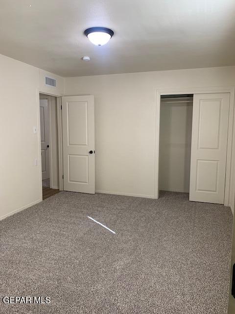 unfurnished bedroom with carpet floors and a closet