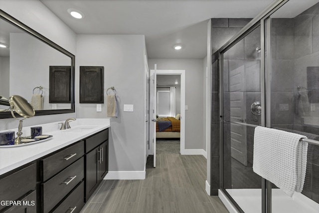 bathroom featuring vanity and an enclosed shower