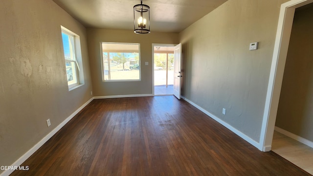 interior space featuring a chandelier and dark hardwood / wood-style flooring