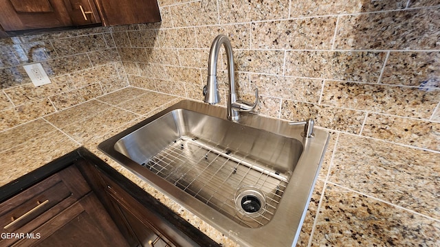 interior details with sink and dark brown cabinets