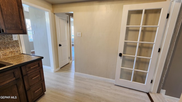 kitchen with backsplash and light wood-type flooring