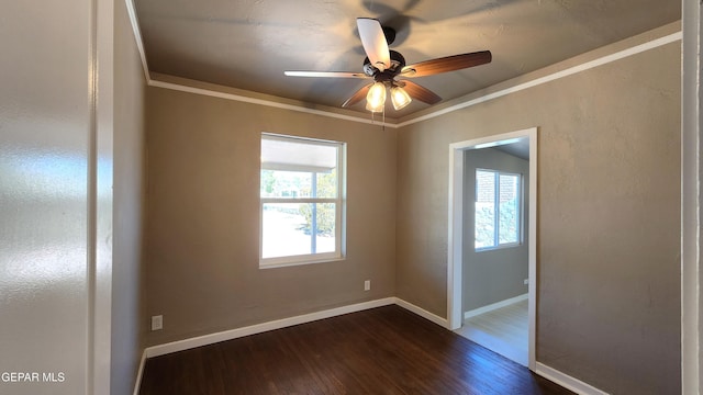 unfurnished room with dark hardwood / wood-style flooring, a wealth of natural light, and ornamental molding