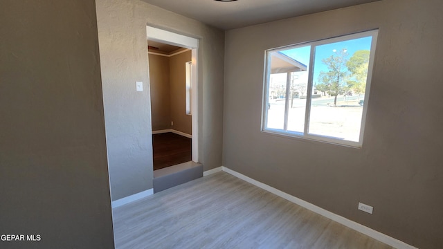 empty room with light hardwood / wood-style flooring