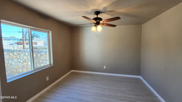 empty room featuring wood-type flooring and ceiling fan