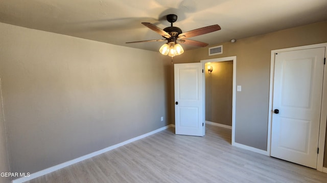 unfurnished bedroom with ceiling fan and light hardwood / wood-style floors