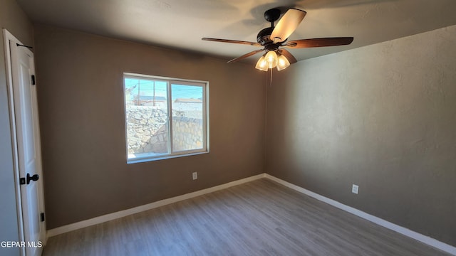 empty room featuring ceiling fan and wood-type flooring