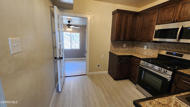 kitchen with tasteful backsplash, dark brown cabinets, appliances with stainless steel finishes, and light hardwood / wood-style flooring