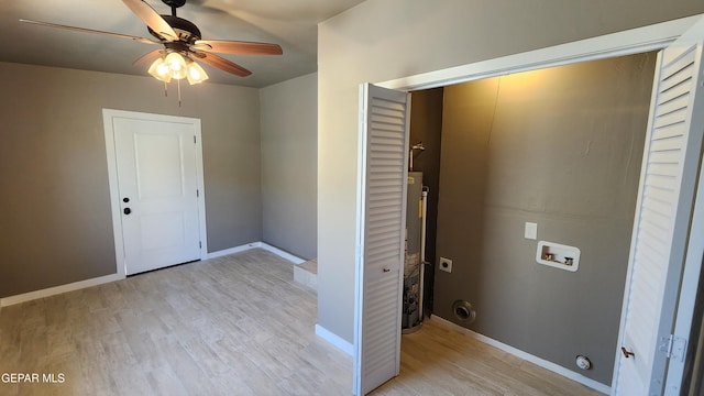 washroom with hookup for a washing machine, hookup for an electric dryer, light hardwood / wood-style floors, and water heater