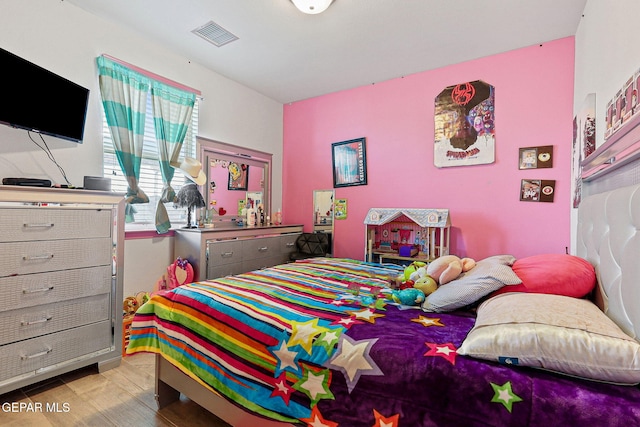 bedroom with light hardwood / wood-style floors