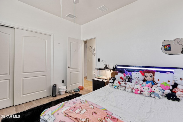 bedroom featuring hardwood / wood-style floors and a closet