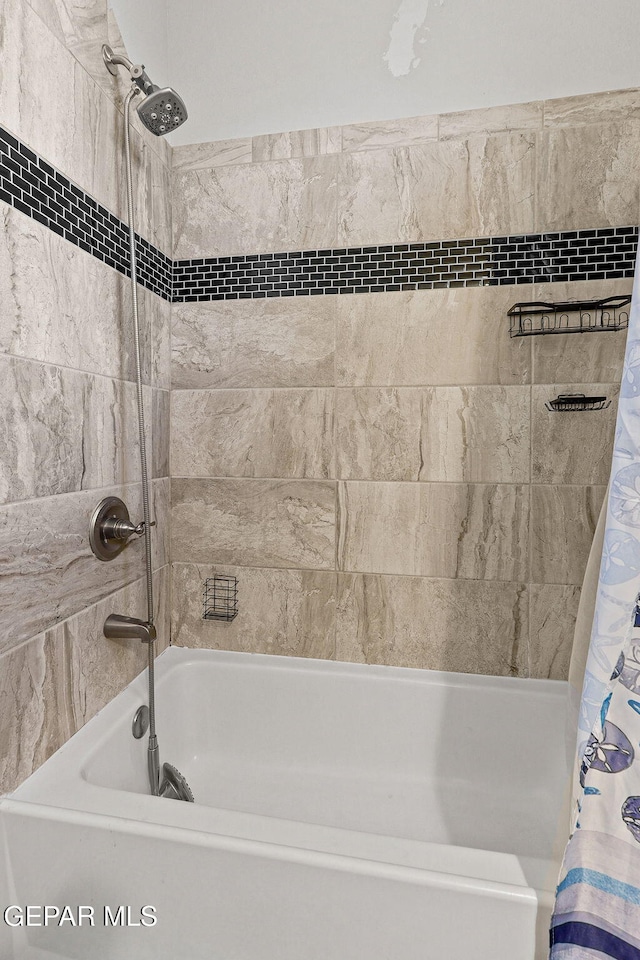 bathroom with shower / bath combo with shower curtain