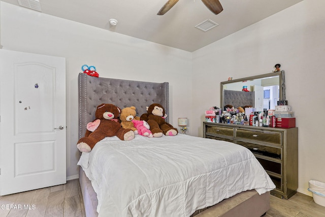 bedroom with light hardwood / wood-style floors and ceiling fan