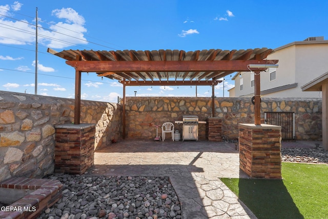 view of patio / terrace featuring a pergola and an outdoor kitchen