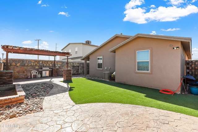 back of house with a patio, a lawn, area for grilling, central air condition unit, and a pergola