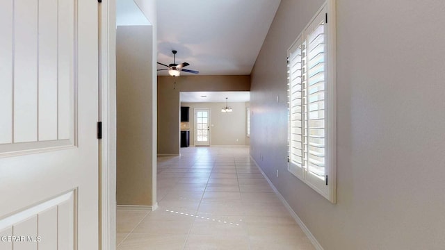 hall featuring light tile patterned floors