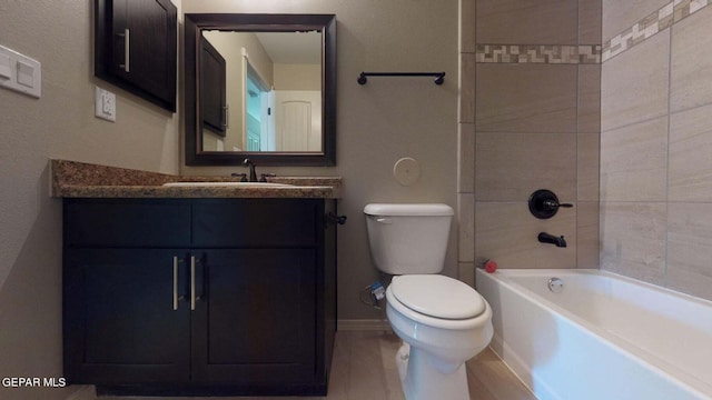 full bathroom featuring tiled shower / bath combo, vanity, and toilet