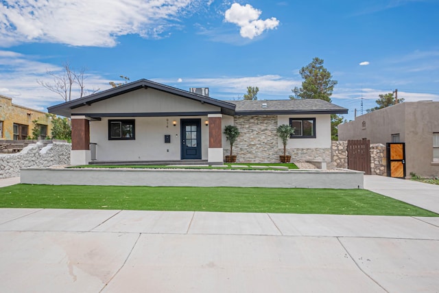 view of front of property with covered porch and a front lawn