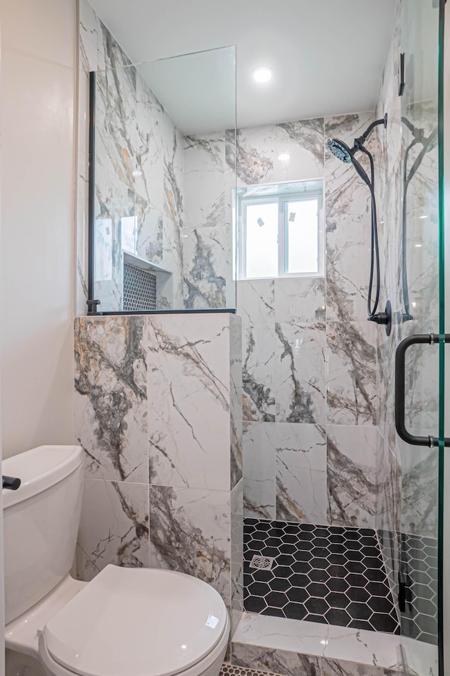 bathroom with toilet and an enclosed shower