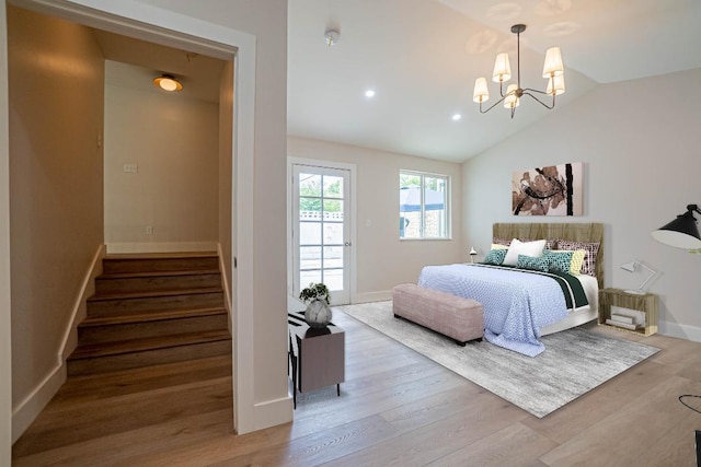 bedroom with vaulted ceiling, access to outside, a chandelier, and light hardwood / wood-style flooring