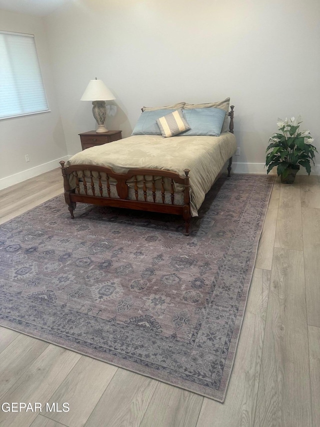 bedroom with hardwood / wood-style floors