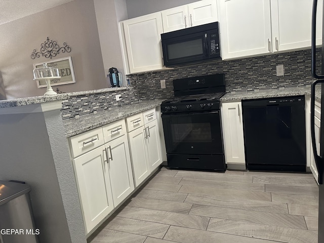 kitchen featuring backsplash, white cabinets, light stone counters, and black appliances