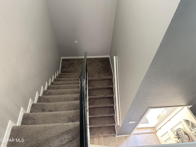 staircase with hardwood / wood-style flooring