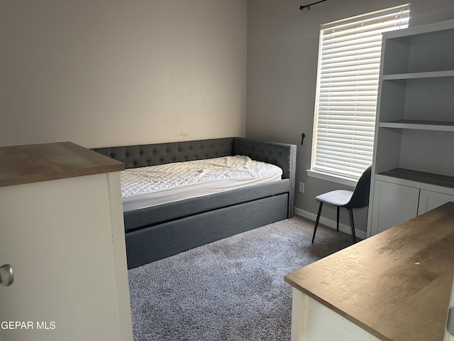 unfurnished bedroom with dark carpet