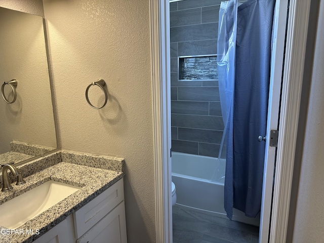 full bathroom with shower / tub combo with curtain, vanity, and toilet