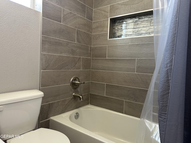 bathroom featuring toilet and shower / bath combo with shower curtain