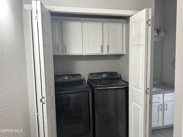 laundry room with cabinets and washer and dryer