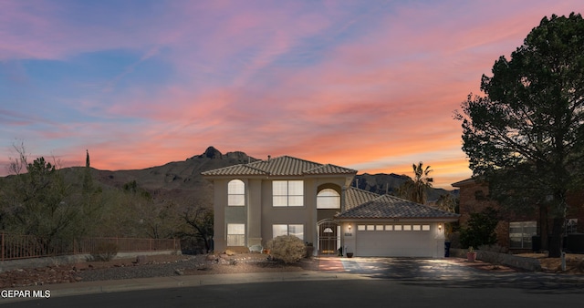 mediterranean / spanish home featuring a garage and a mountain view