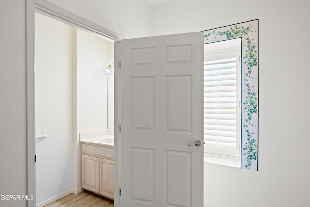 hall with light hardwood / wood-style floors