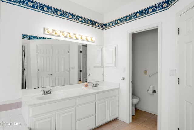 bathroom with tile patterned floors, vanity, and toilet