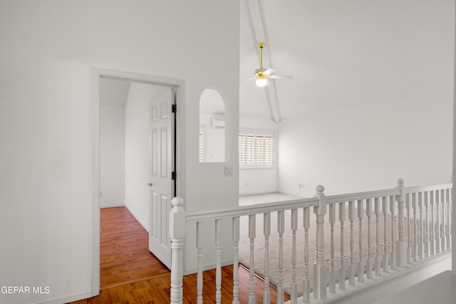 hallway with lofted ceiling and wood-type flooring