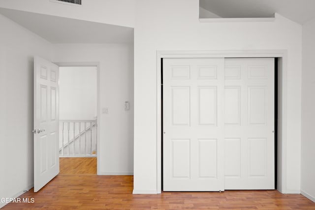 unfurnished bedroom featuring light hardwood / wood-style floors and a closet