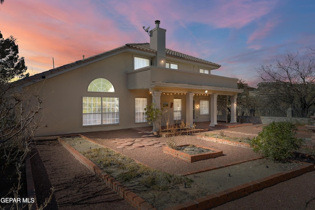 view of back house at dusk