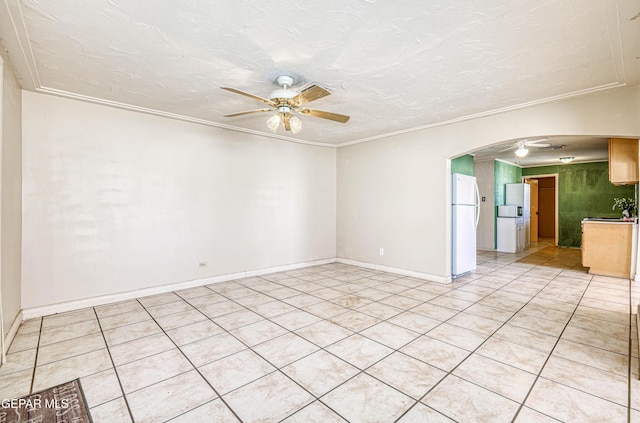 spare room with ornamental molding, light tile patterned floors, a textured ceiling, and ceiling fan