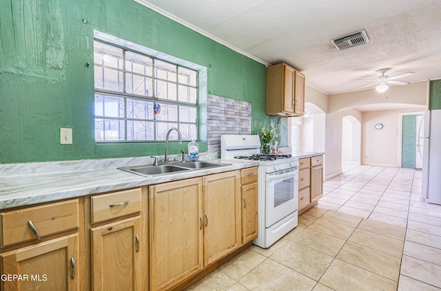 kitchen featuring sink, crown molding, white appliances, light tile patterned floors, and ceiling fan