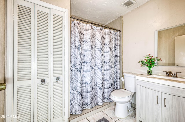 bathroom with vanity, a textured ceiling, and toilet