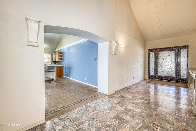 foyer featuring high vaulted ceiling