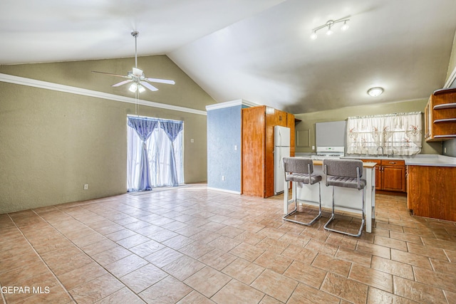 kitchen featuring high vaulted ceiling, a breakfast bar area, white fridge, range, and ceiling fan