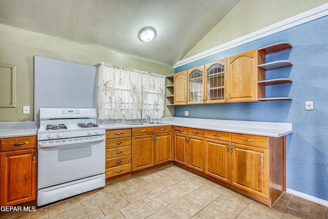 kitchen with vaulted ceiling, sink, and white gas stove