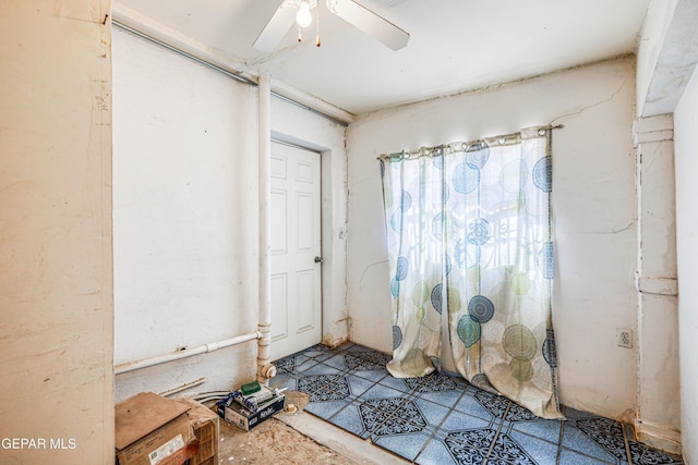 interior space with ceiling fan