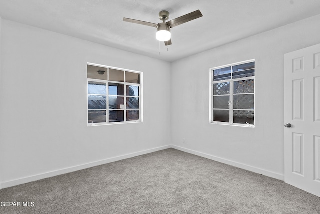 empty room with ceiling fan and carpet flooring