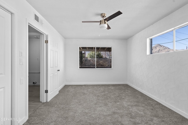 unfurnished bedroom featuring ceiling fan and carpet