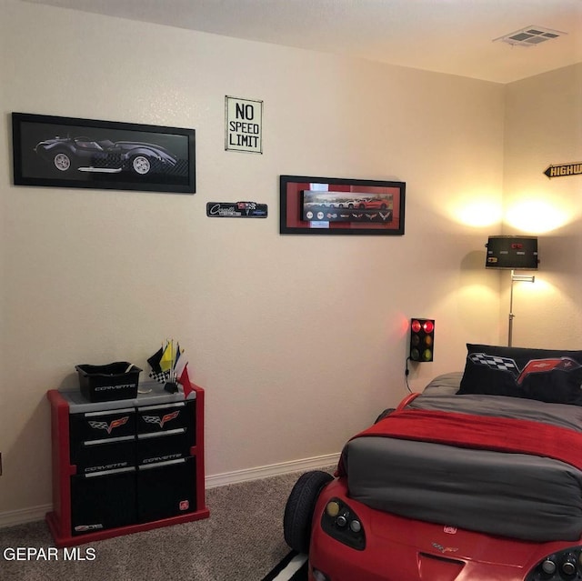 carpeted bedroom with visible vents and baseboards