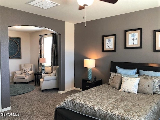 bedroom featuring baseboards, visible vents, arched walkways, ceiling fan, and carpet flooring