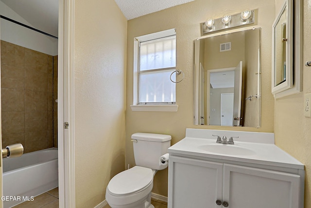 full bathroom featuring tiled shower / bath, vanity, toilet, and tile patterned flooring