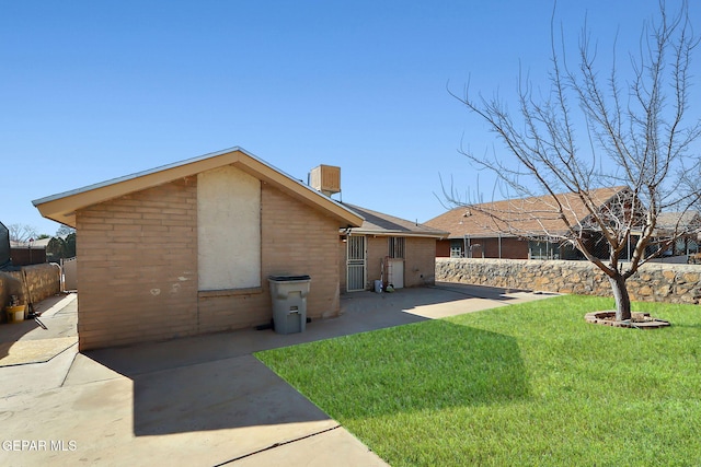 back of house with a yard and a patio area