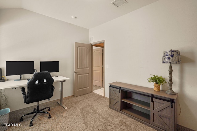 carpeted office with vaulted ceiling